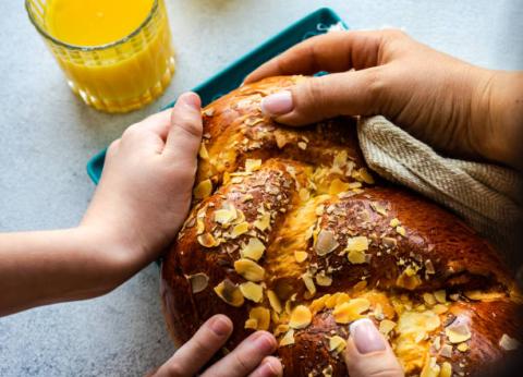 hands tearing bread