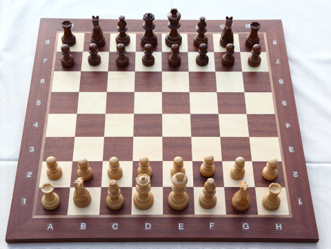 Brown and white chess board set up to play