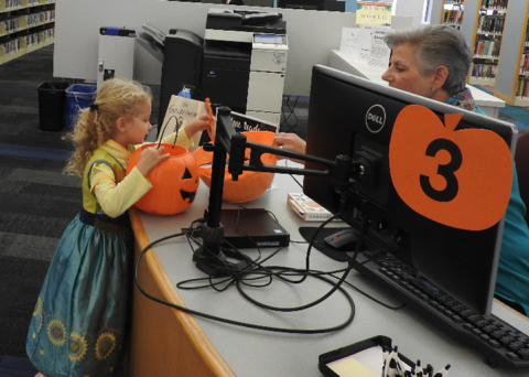 Girl trick or treats at desk #3