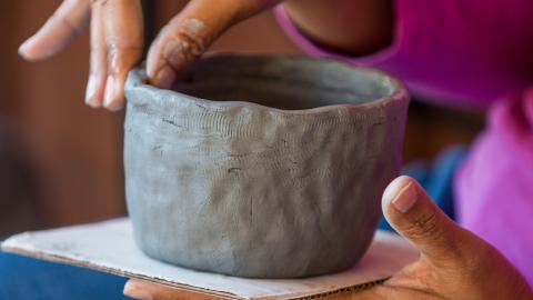 Woman making a pinch pot