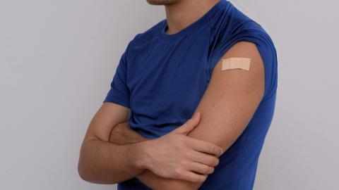 person with sleeve pulled up and wearing bandage