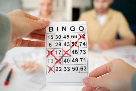 Person holding a bingo card up toward the camera